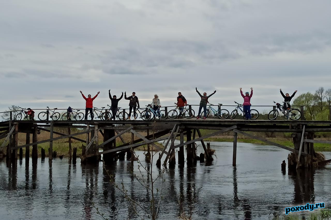 Велотуристы 1 мая проезжают реку Судогда по мосту.